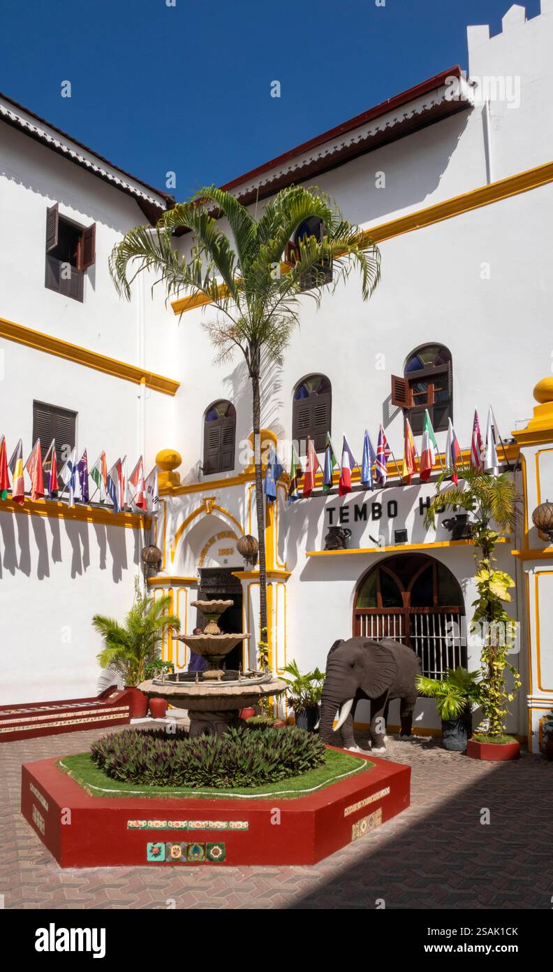 Africa Tanzania, Zanzibar, Stonetown, Shangani Street, international flags outside Tembo House Hotel facade Stock Photo