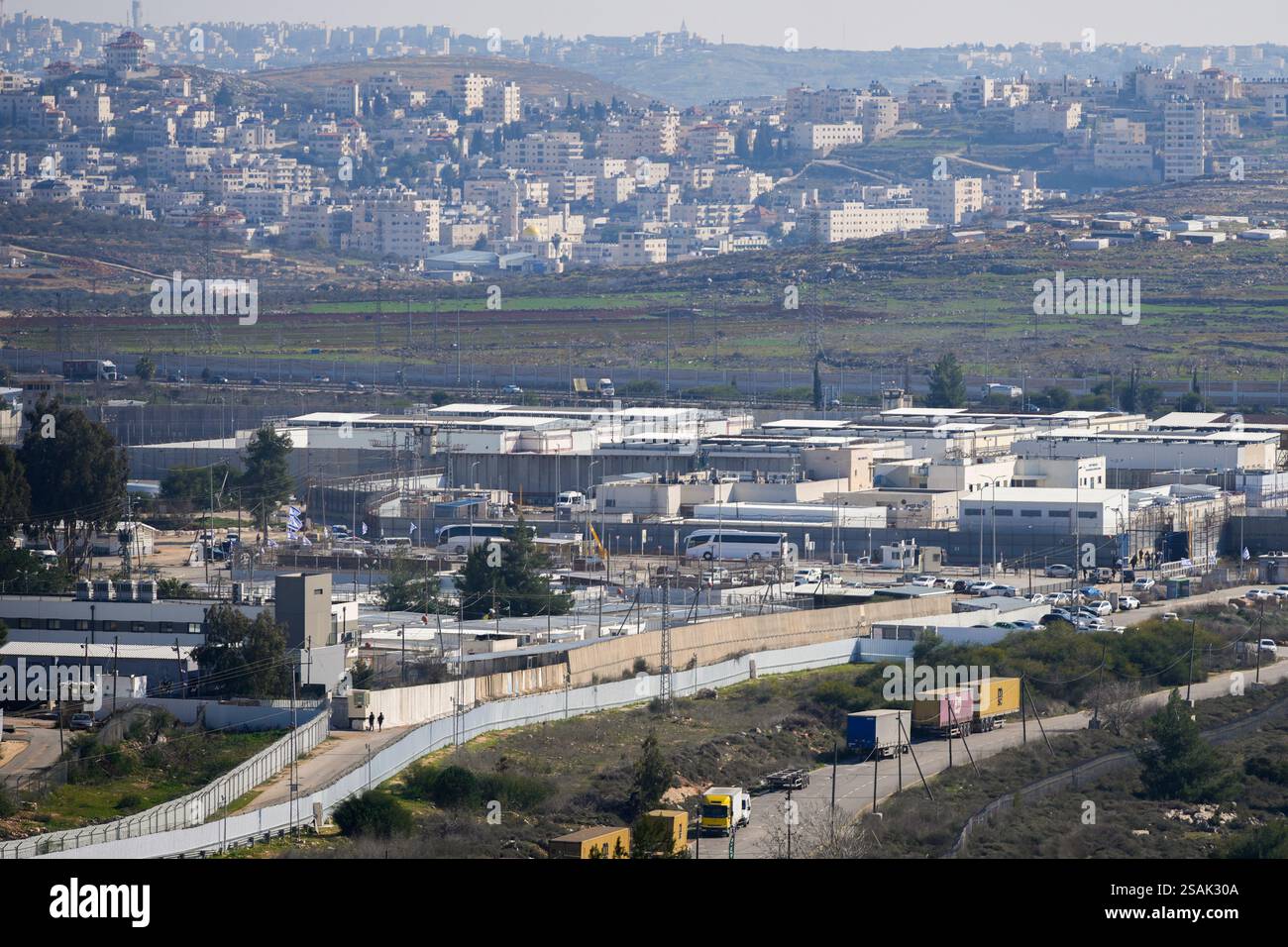 Two white buses, center, are lined up at the Israeli Ofer prison in the ...