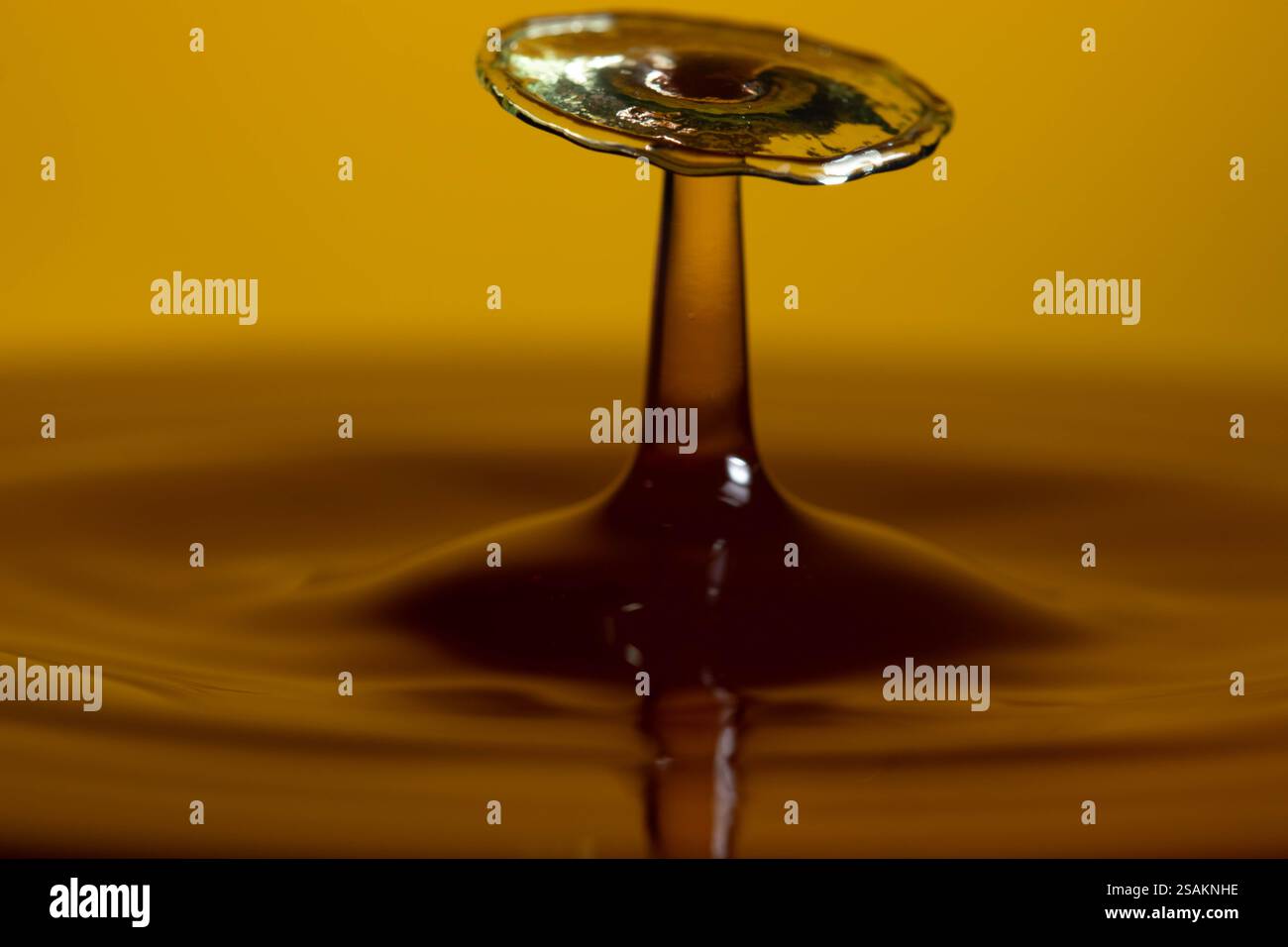 Splashart water collision on yellow background Stock Photo