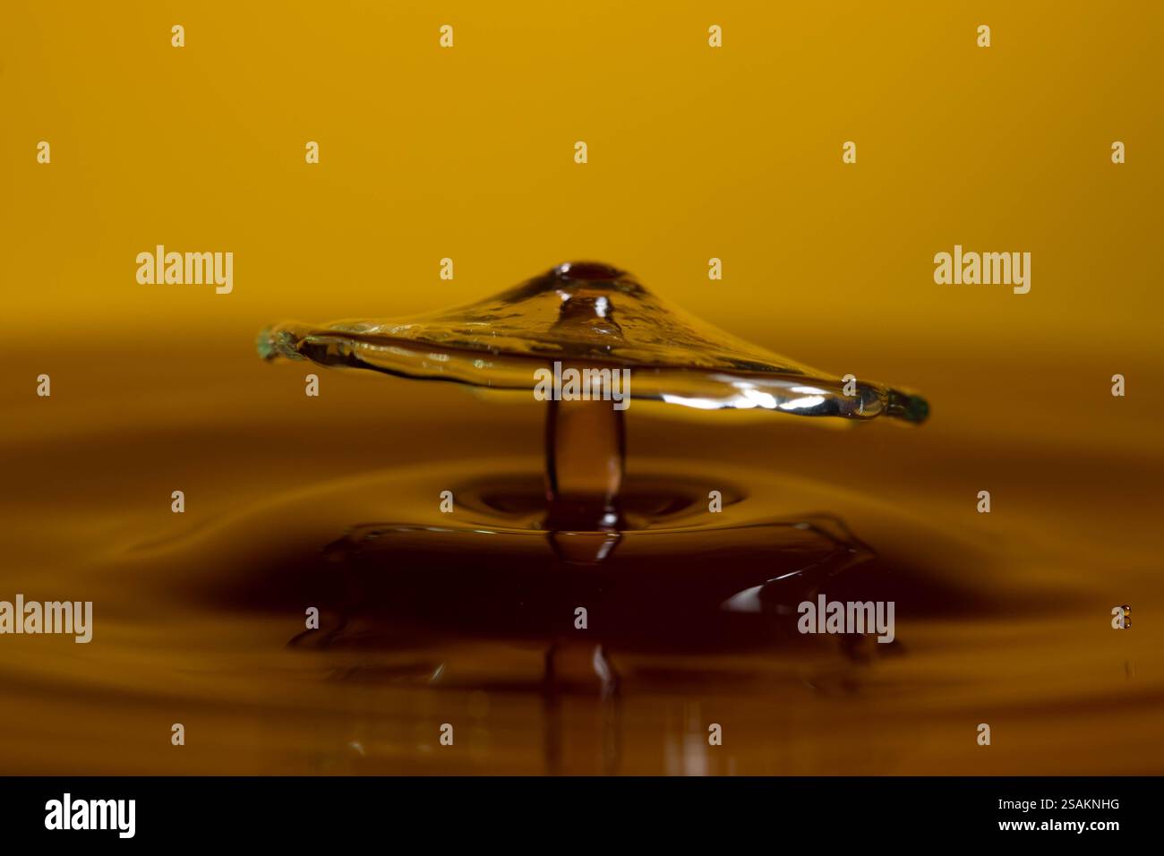 Splashart water collision on yellow background Stock Photo