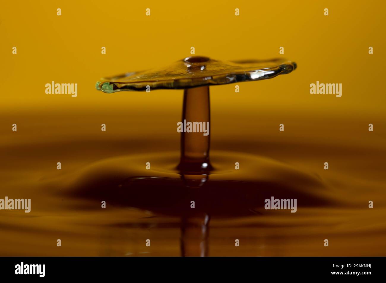 Splashart water collision on yellow background Stock Photo