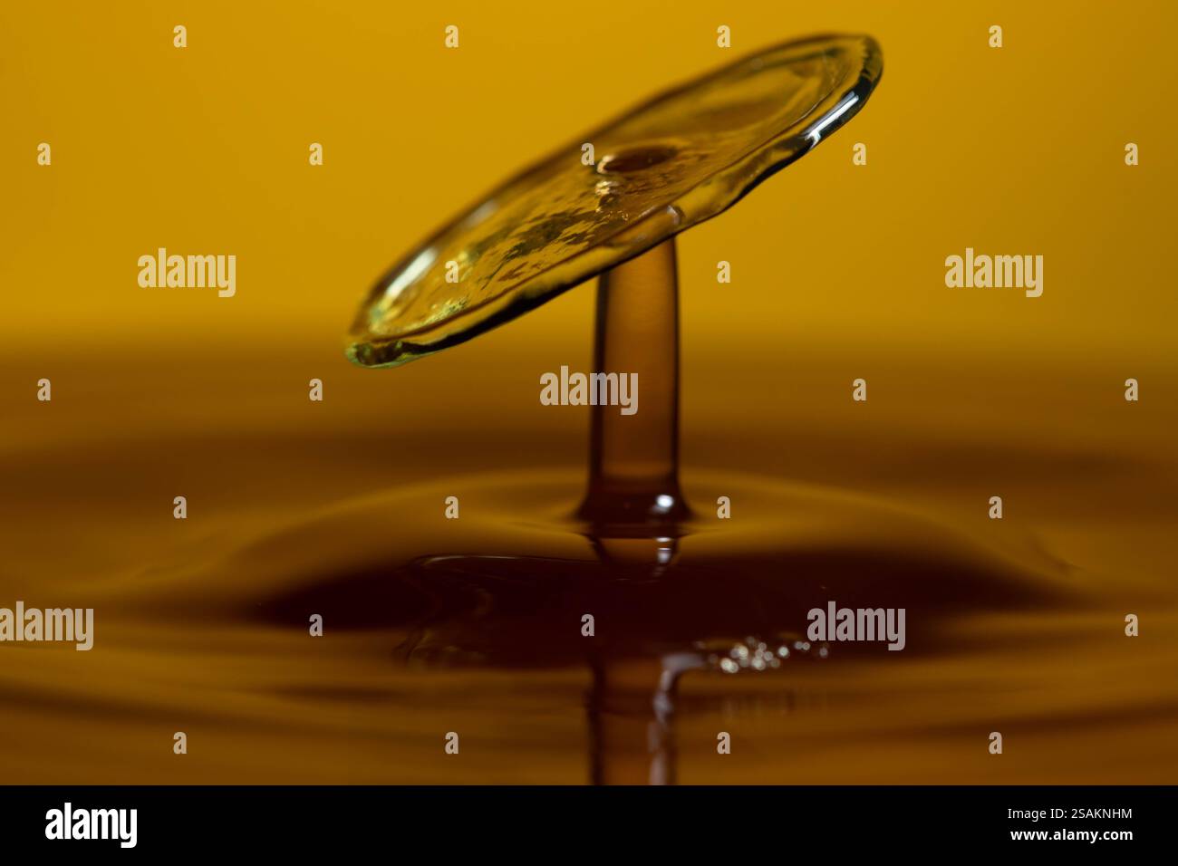 Splashart water collision on yellow background Stock Photo