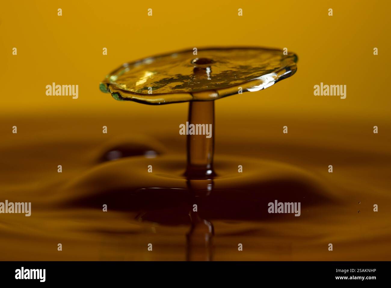 Splashart water collision on yellow background Stock Photo