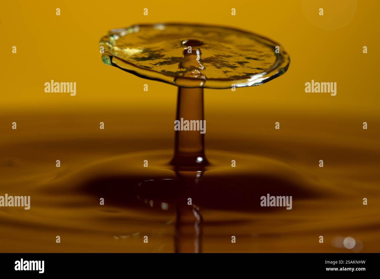 Splashart water collision on yellow background Stock Photo