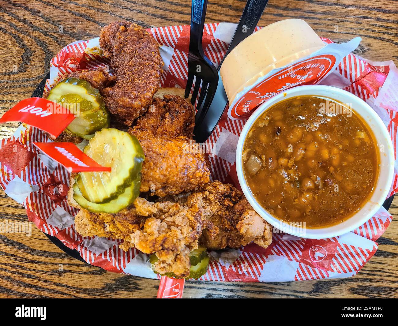 Nashville Hot Chicken and Pickles with Baked Beans Overhead View Stock Photo