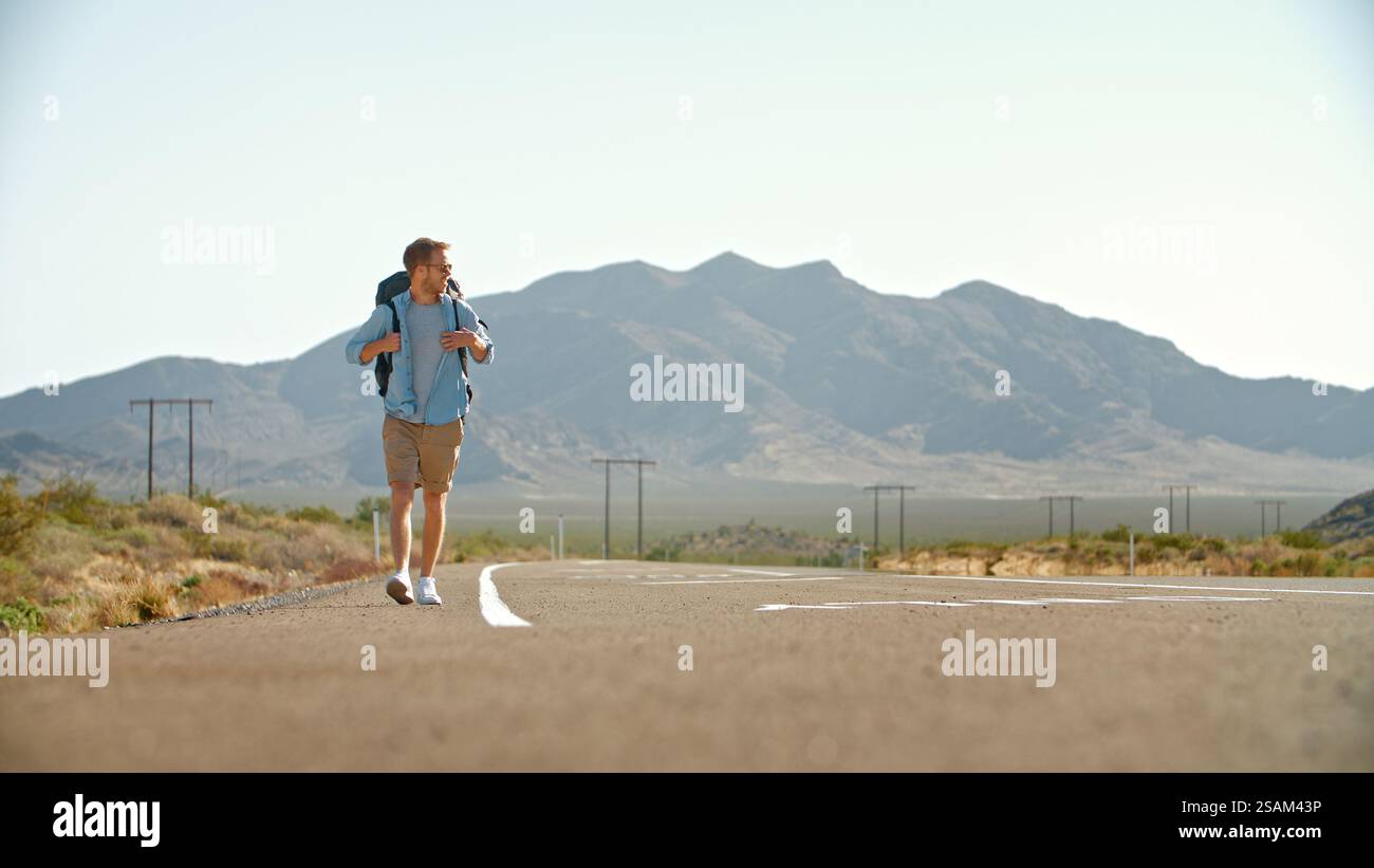 Young man walking empty road hi-res stock photography and images - Alamy