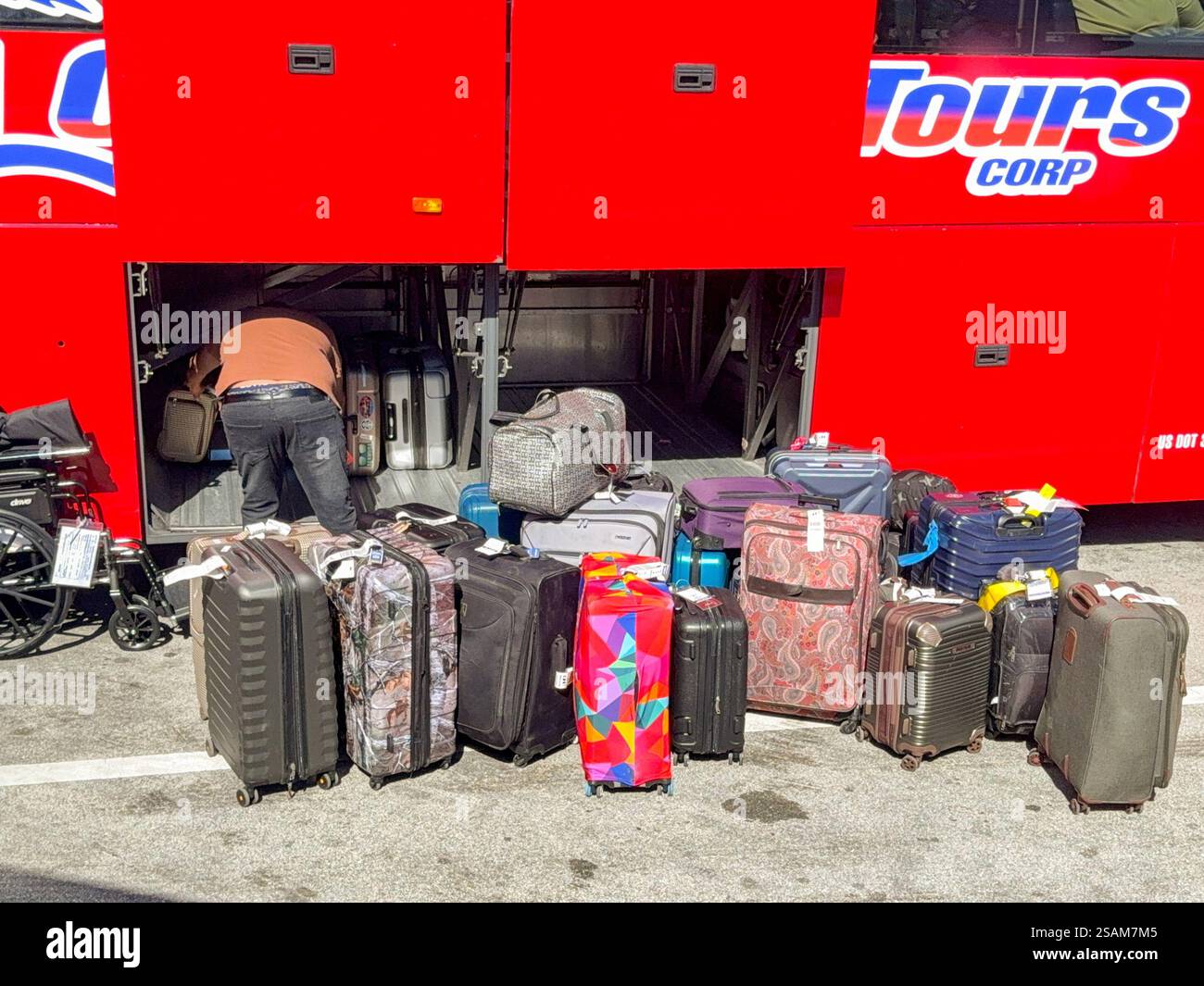 Miami, Florida, USA - 4 January 2024: Coach driver unloading luggage from a tour bus at one of the cruise terminals in the Port of Miami - Smartphone Captured Stock Image