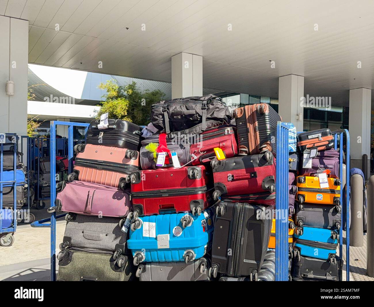Miami, Florida, USA - 4 January 2024: Luggage stacked on trolleys for loading onto a cruise ship. - Smartphone Captured Stock Image