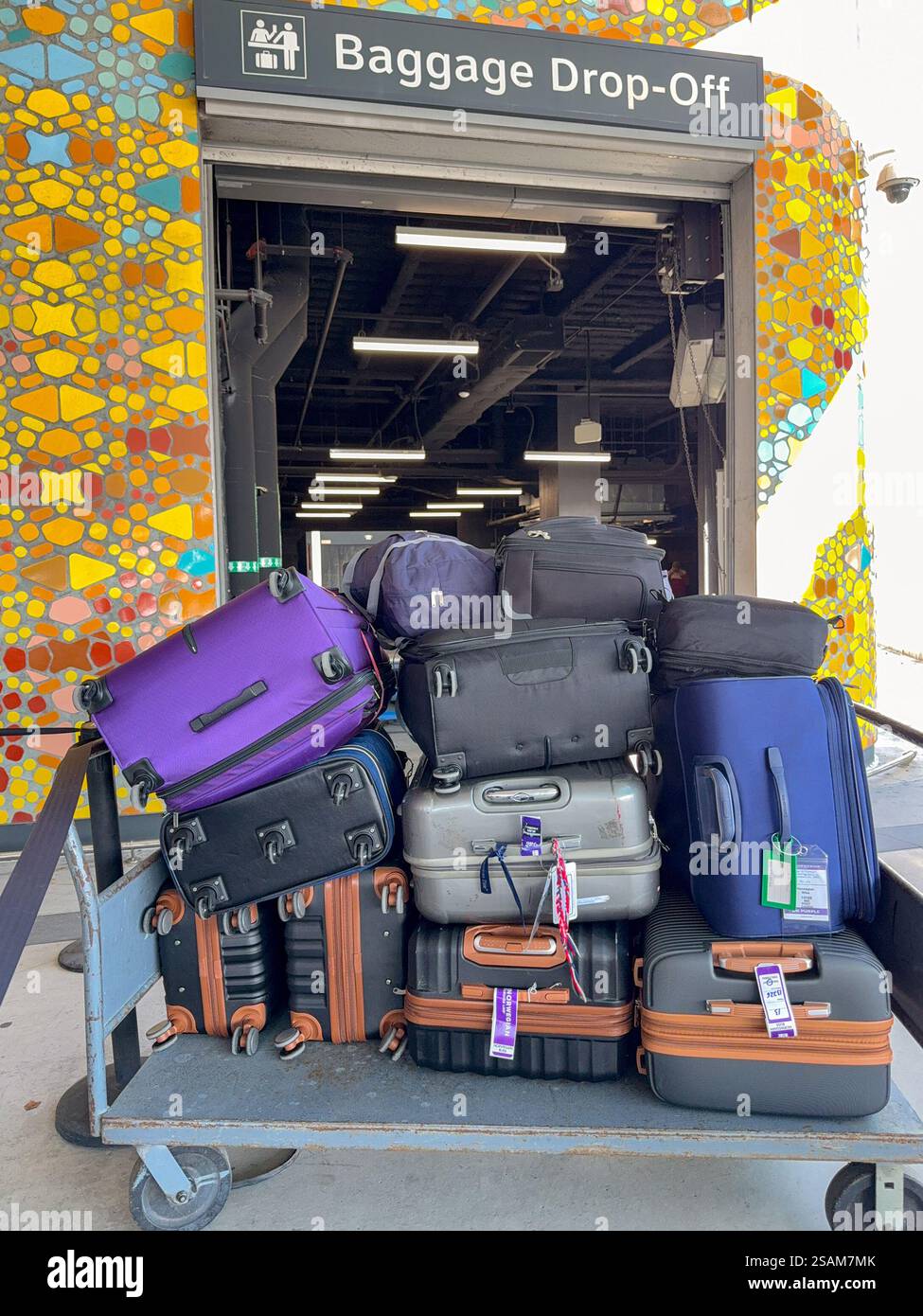 Miami, Florida, USA - 4 January 2025: Luggage cart with suitcases outside the baggage drop-off point at the terminal for the Norwegian Cruise Line - Smartphone Captured Stock Image