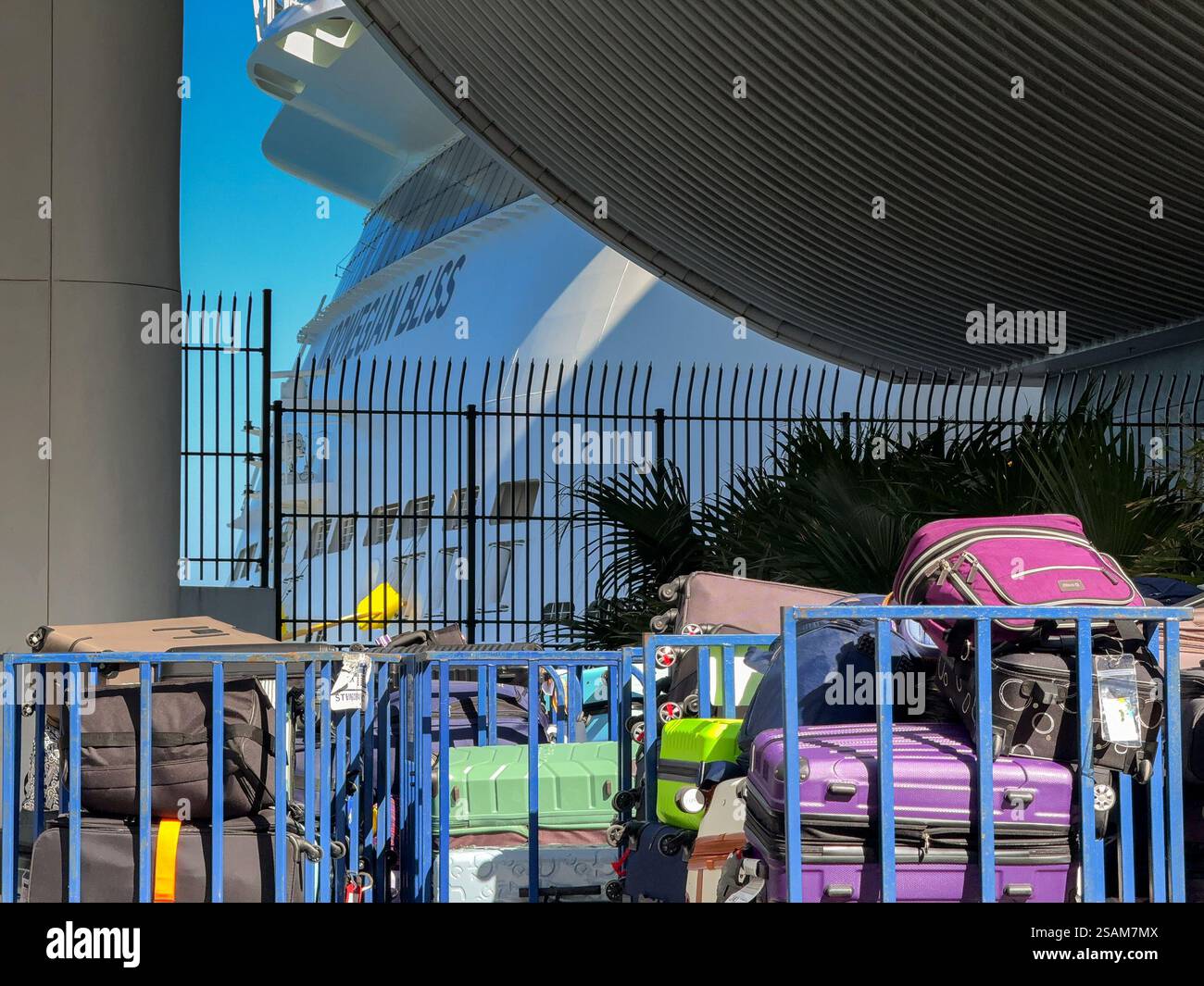 Miami, Florida, USA - 4 January 2024: Luggage stacked on trolleys for loading onto a cruise ship. In the background is the Norwegian Bliss cruise ship - Smartphone Captured Stock Image