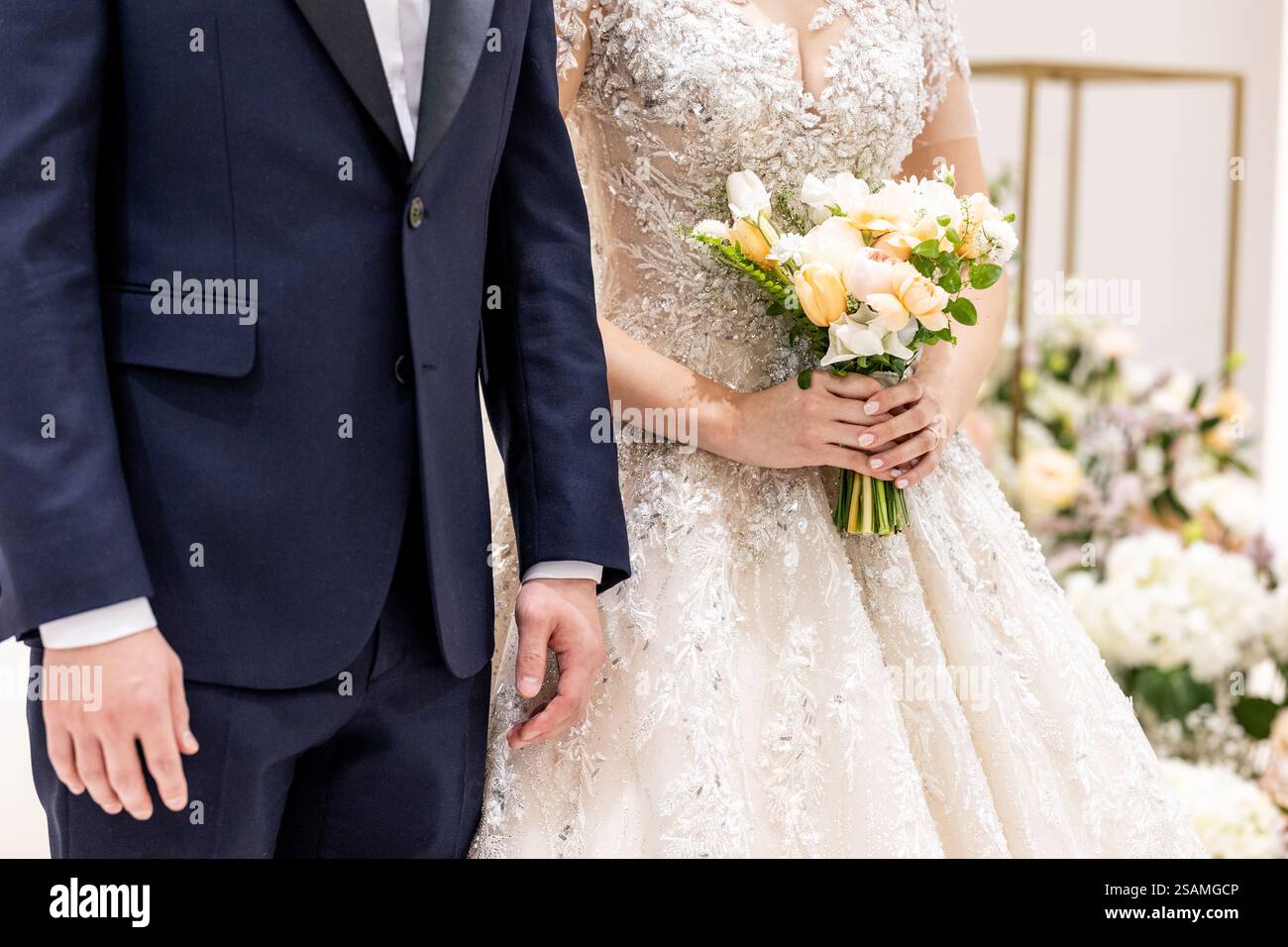 Man and a woman are standing next to each other. The man is wearing a ...