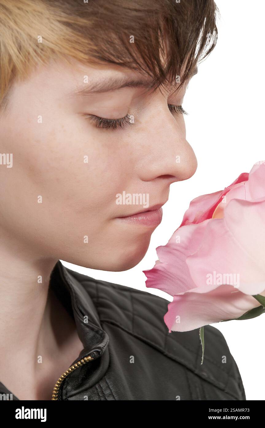 Beautiful woman smelling a fresh cut rose Stock Photo - Alamy