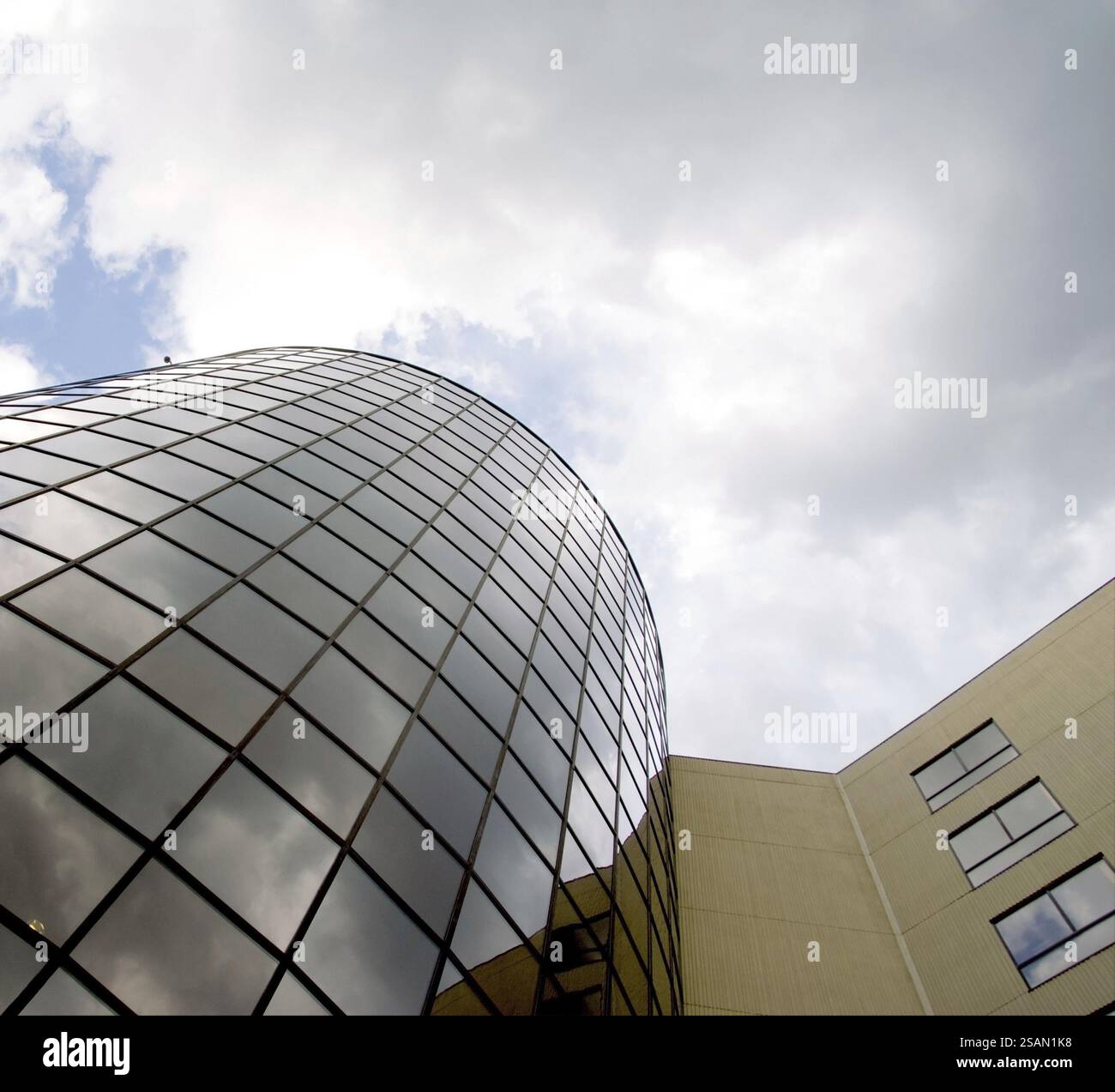 A tall glass building reflecting the image of the sky Stock Photo - Alamy