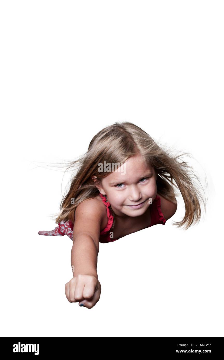 Beautiful little girl super hero flying through the sky Stock Photo - Alamy