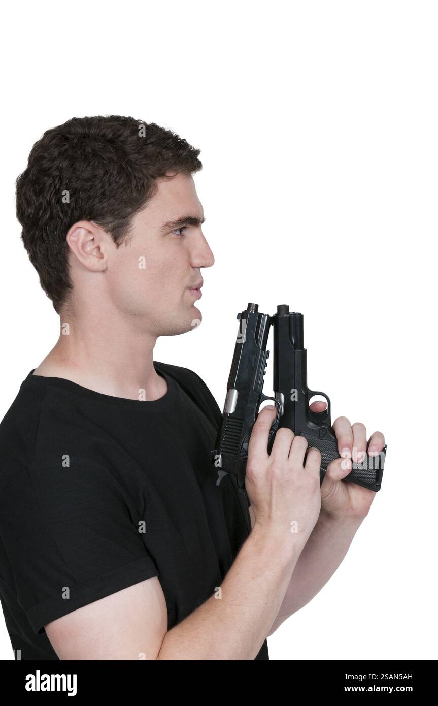 Handsome young man holding a hand gun pistol Stock Photo - Alamy