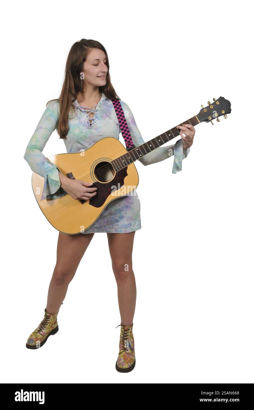 Beautiful young woman playing an acoustic guitar Stock Photo - Alamy