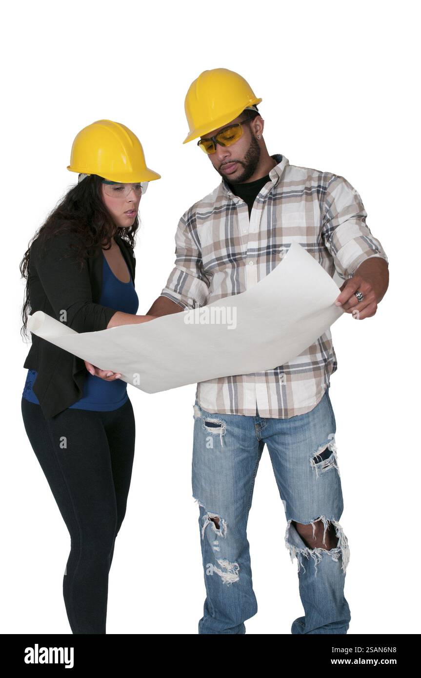 Construction Worker on a job site inspecting blueprints Stock Photo