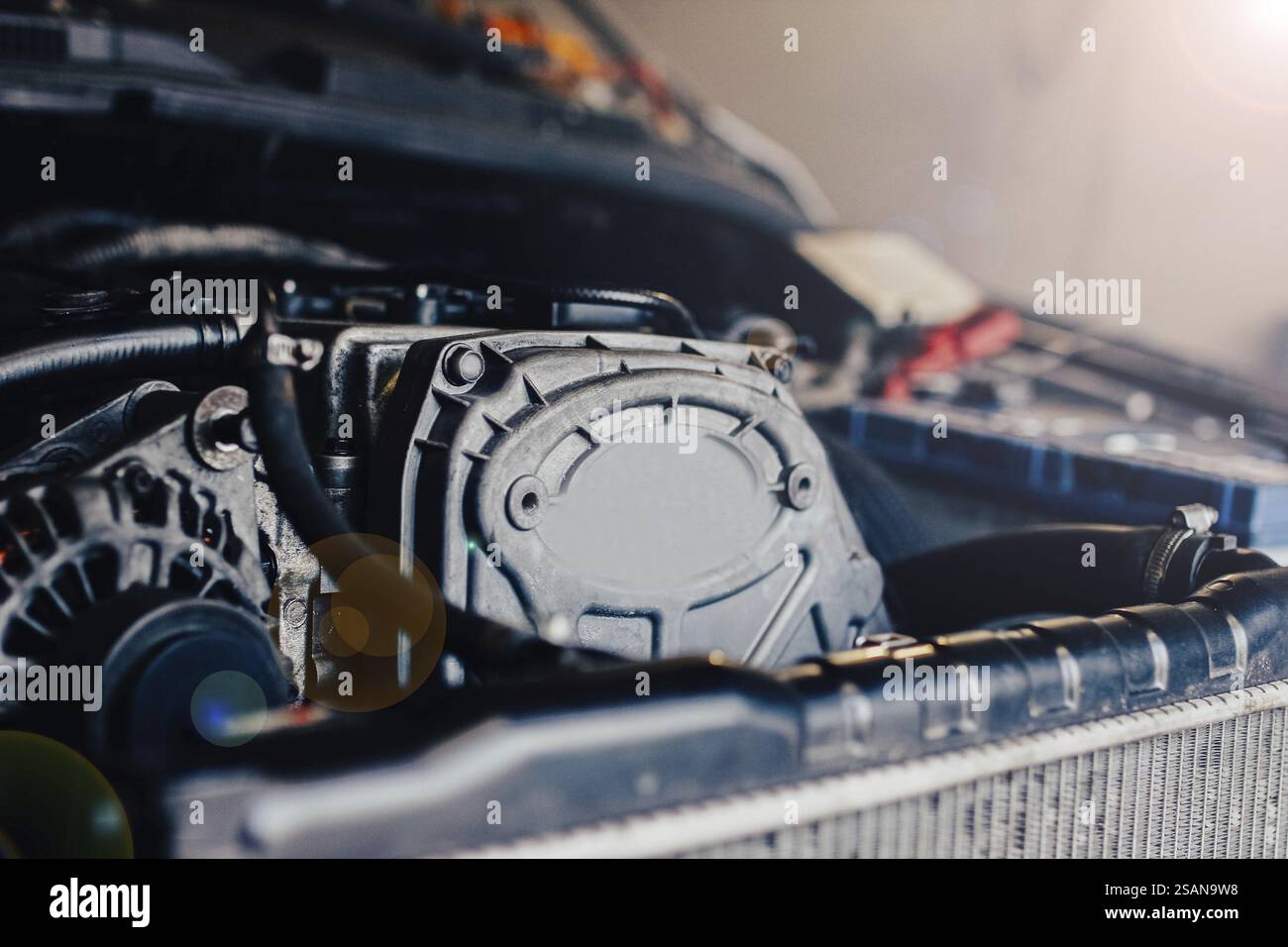Sunlight Engine Close-up of a car engine with visible machinery and sunlight filtering ...