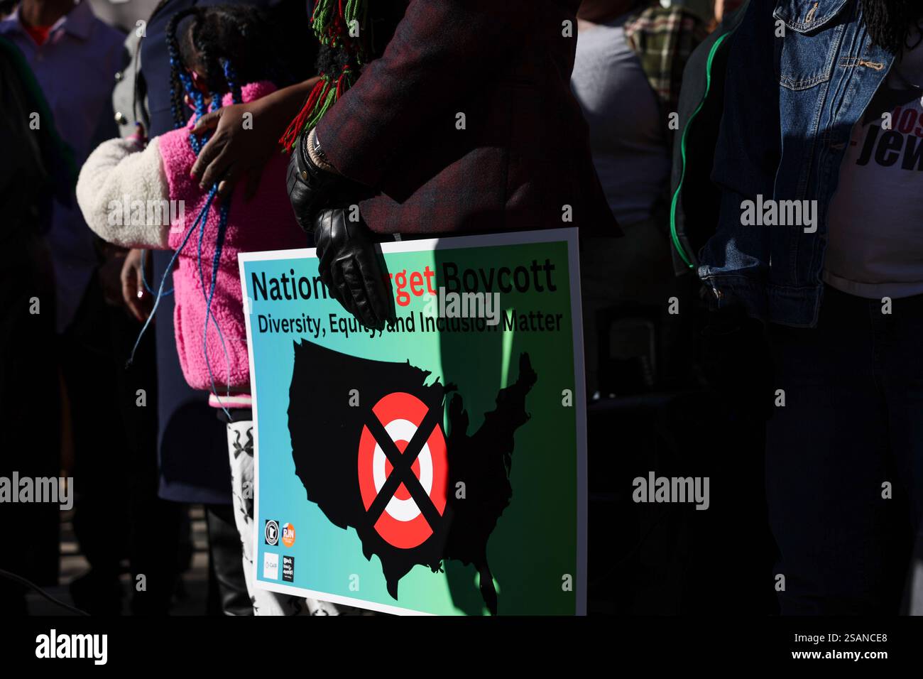 A community member holds a sign calling for a national boycott of