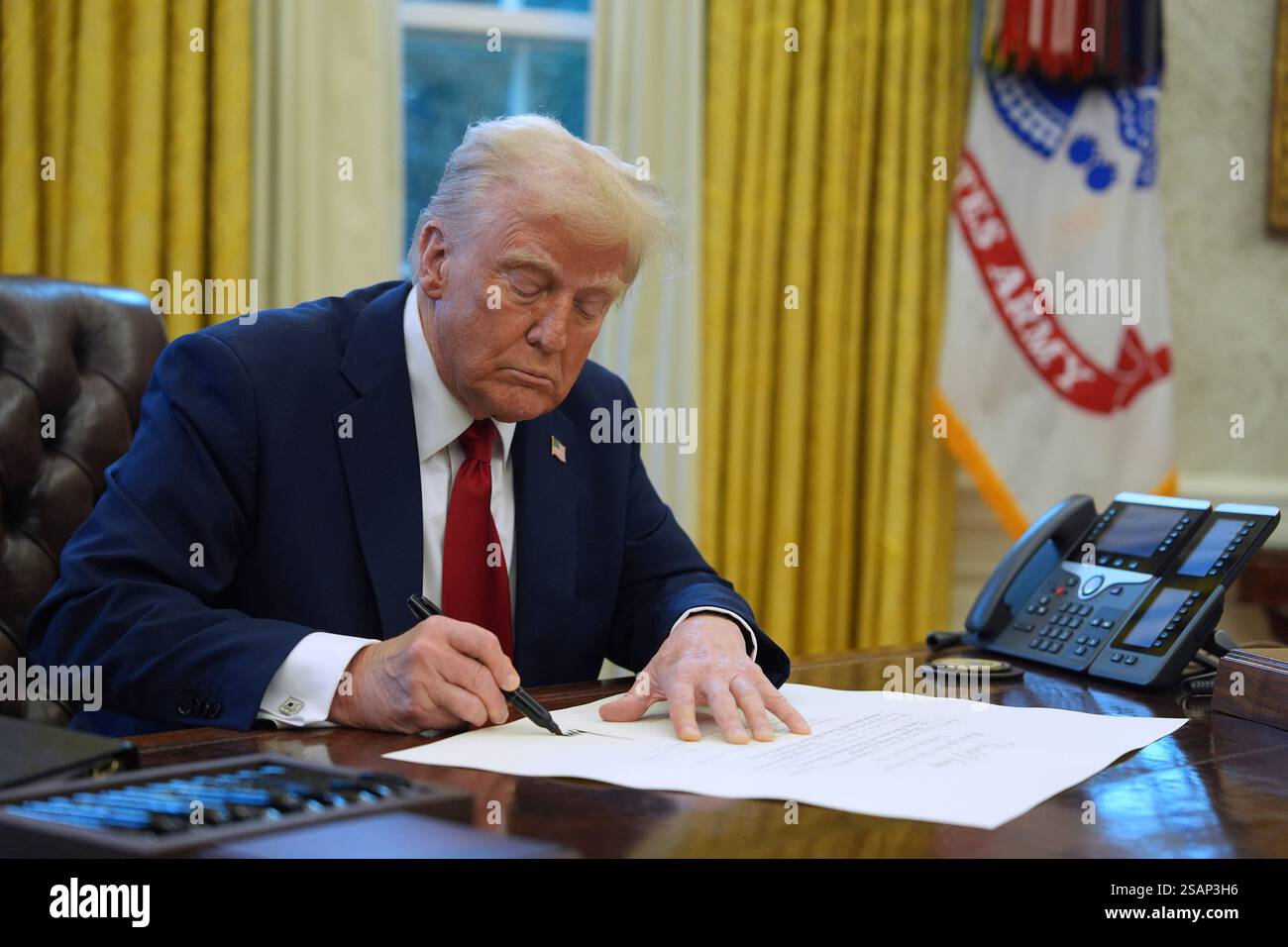 President Donald Trump signs executive orders in the Oval Office at the