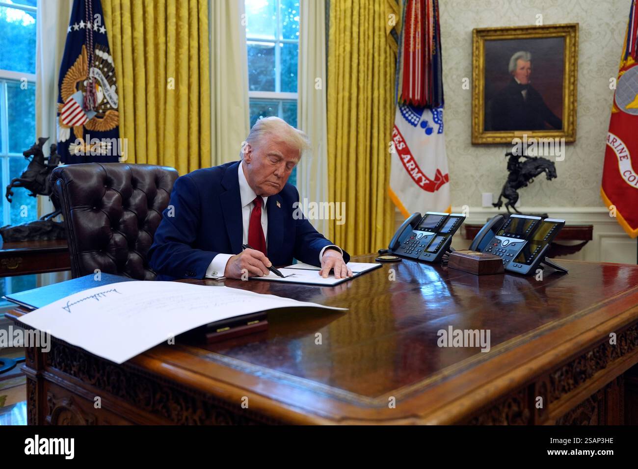 President Donald Trump signs executive orders in the Oval Office at the
