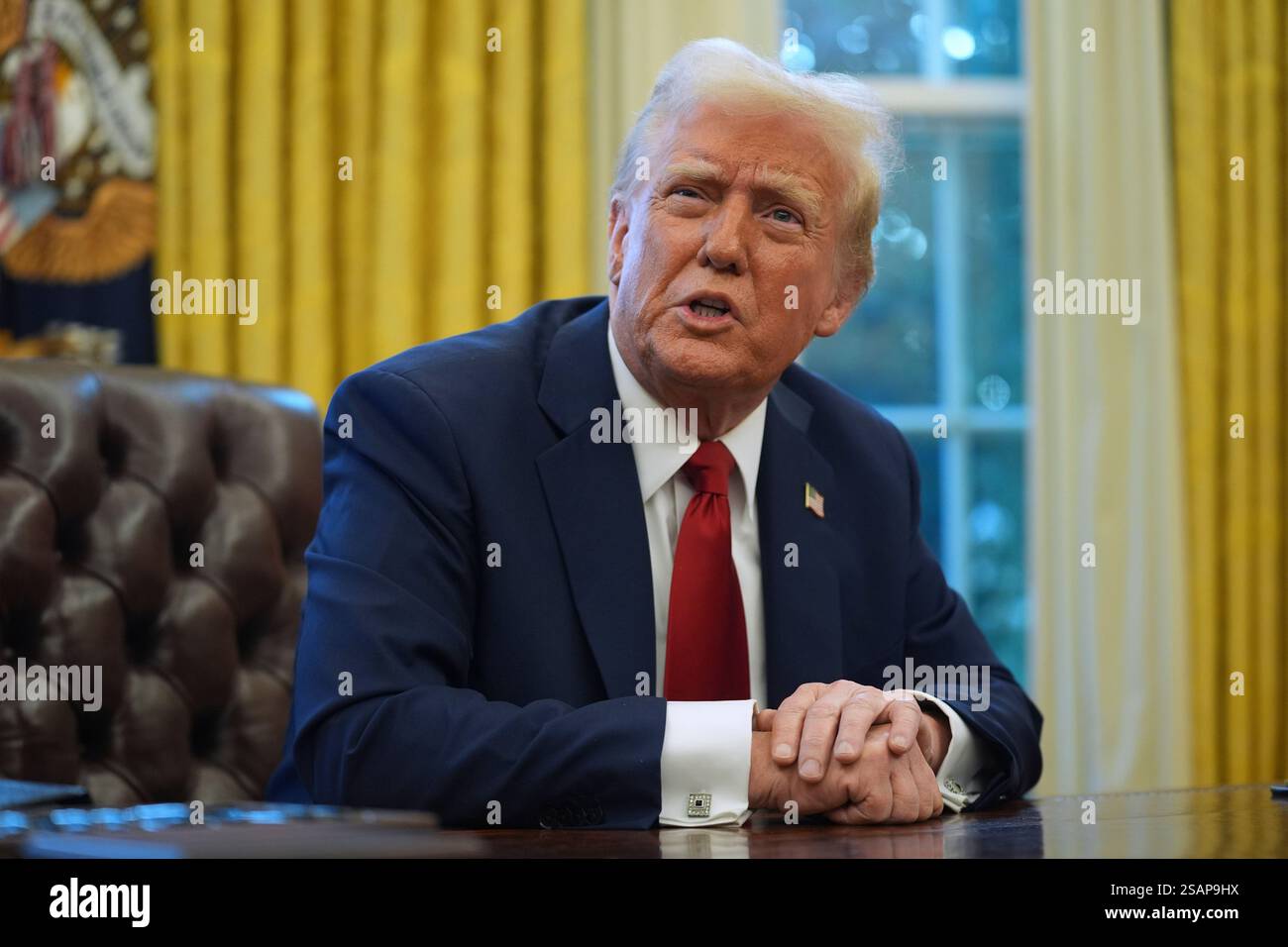 President Donald Trump speaks as he signs executive orders in the Oval