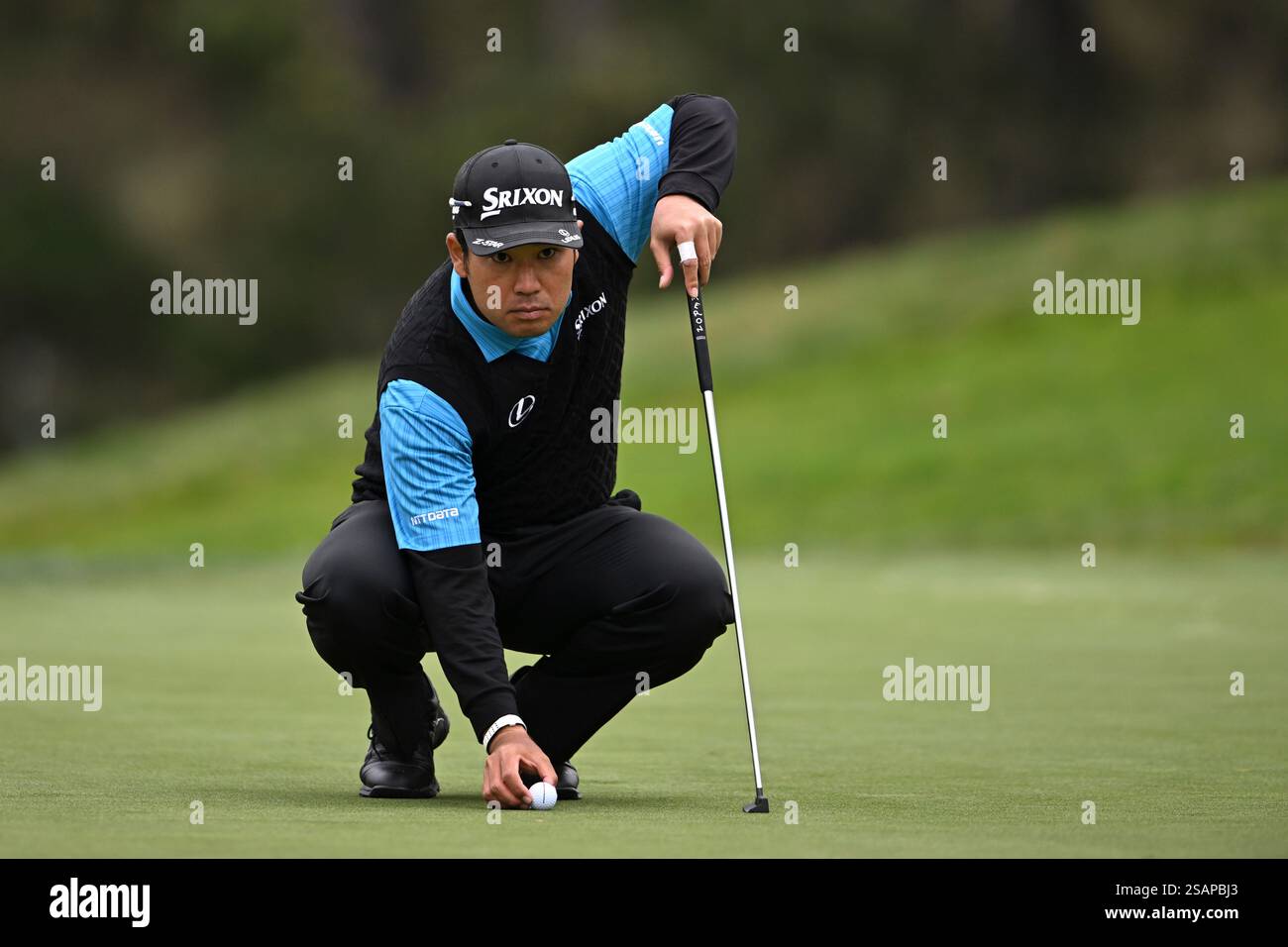 Hideki Matsuyama of Japan lines up a putt on the 14th hole during the