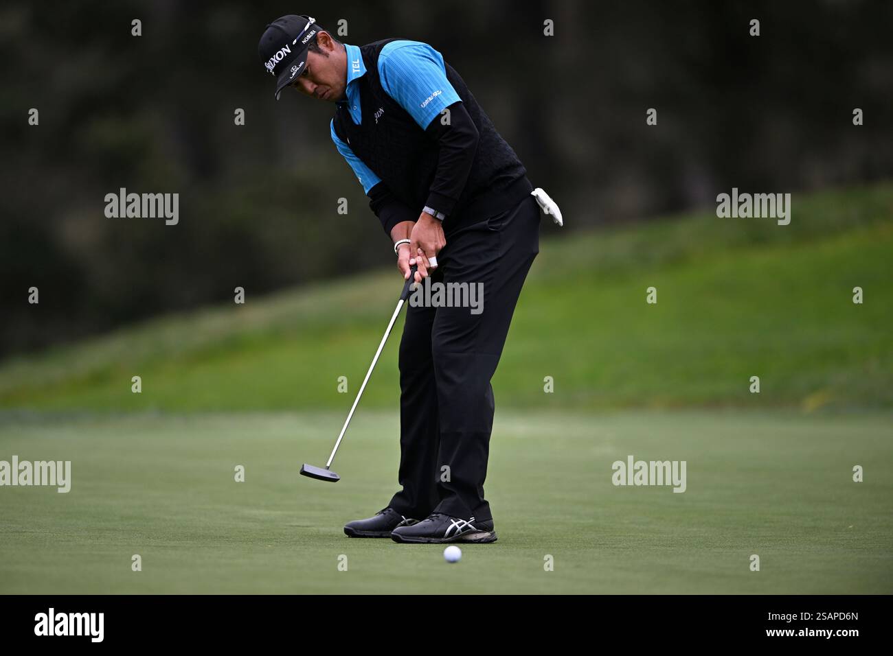 Hideki Matsuyama of Japan putts on the 14th hole during the first round