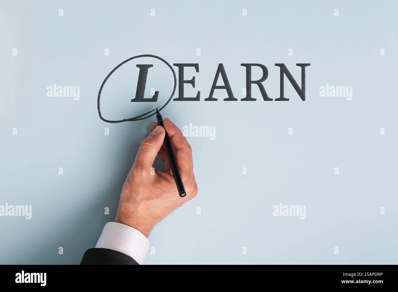 A hand circles the L in LEARN, symbolizing the concept that learning is ...