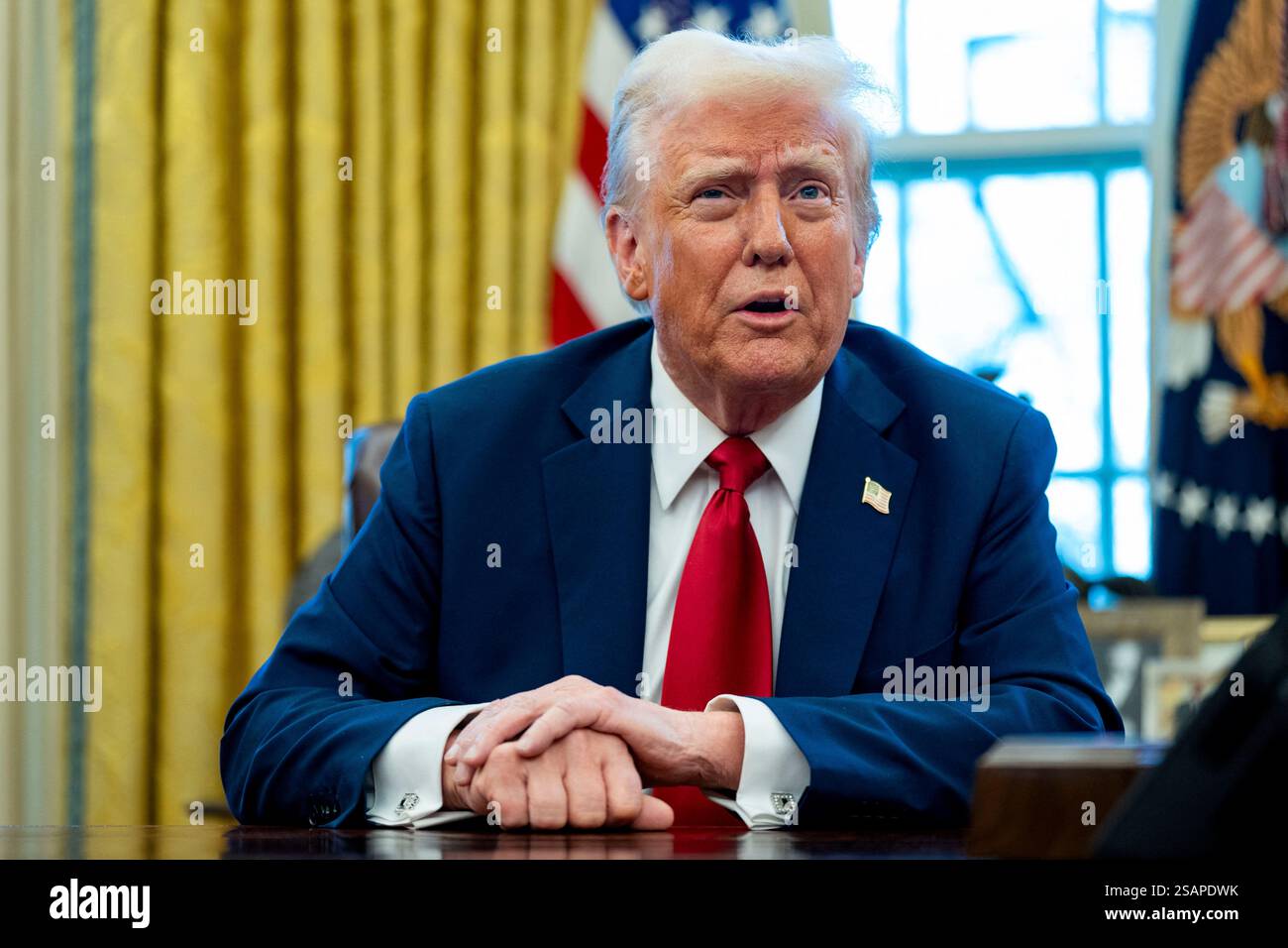 President Donald Trump signs two executive orders in the Oval Office of ...