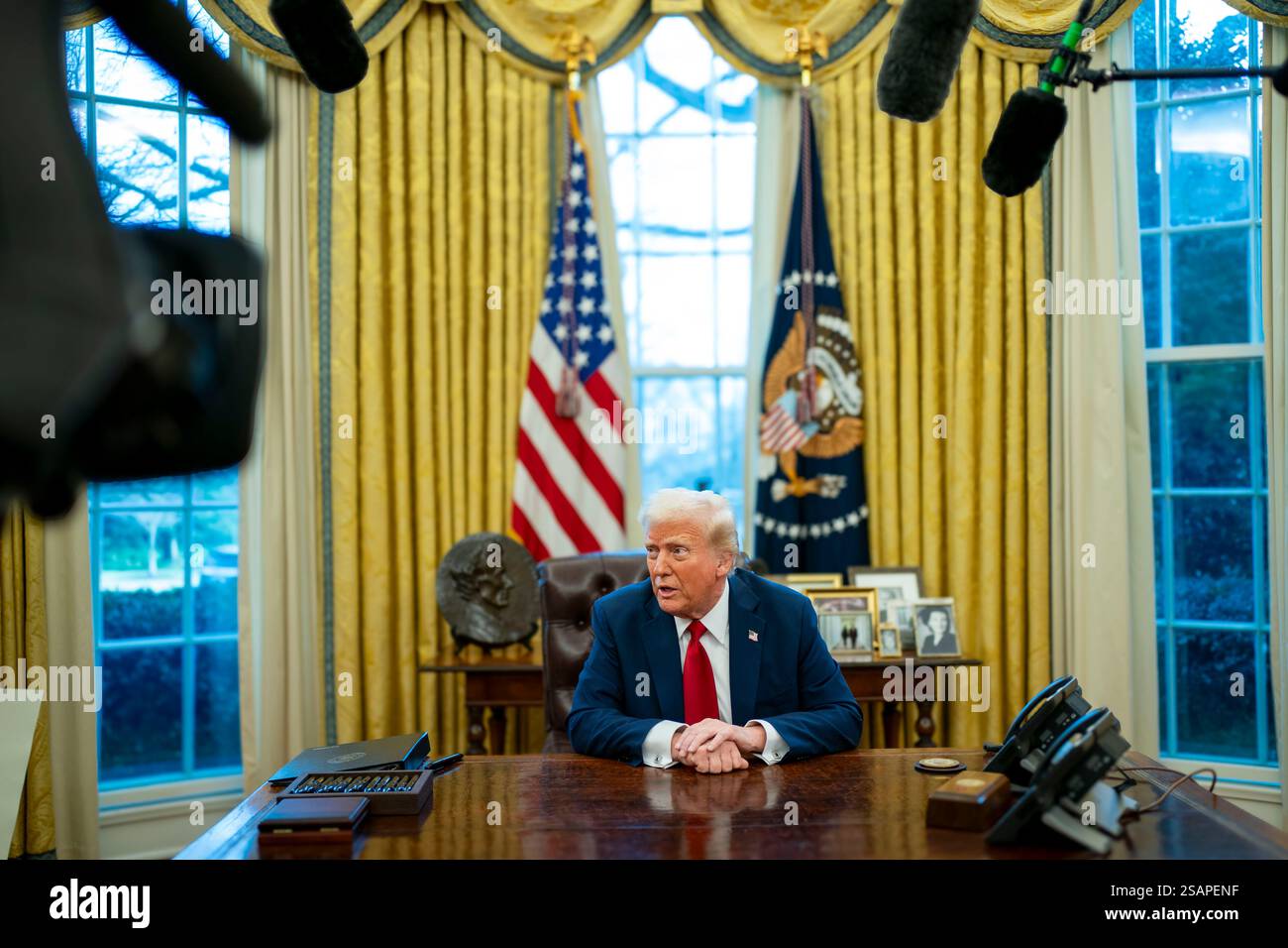 President Donald Trump signs two executive orders in the Oval Office of ...