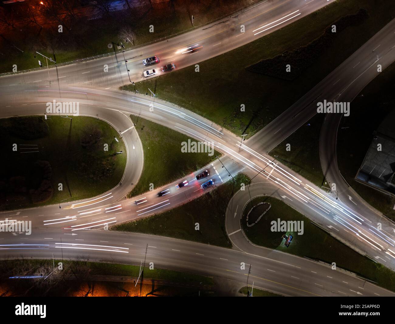 Top down aerial view of a night intersection with a moving traffic ...