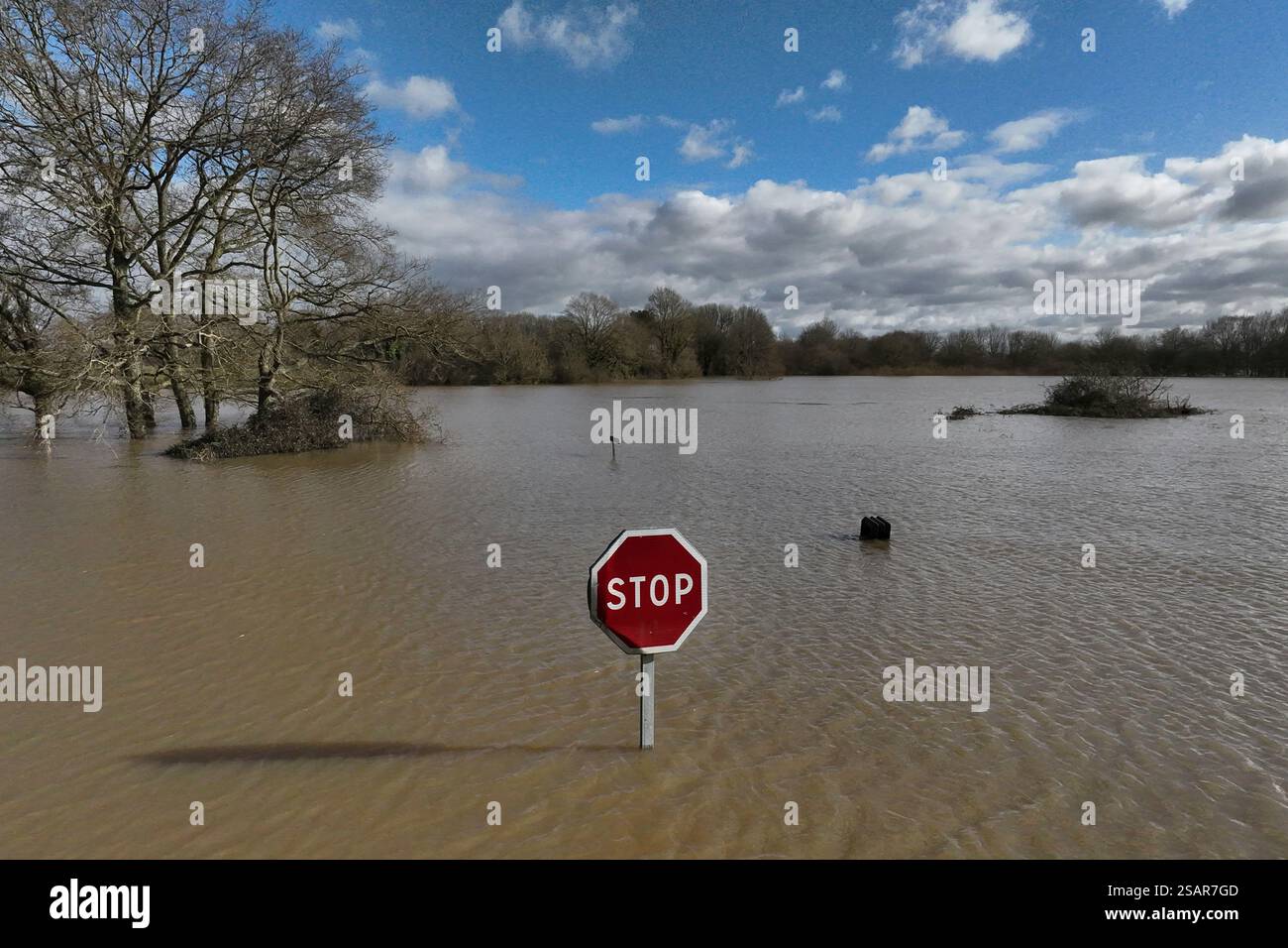 A road sign rises above the water as severe flooding hits western ...