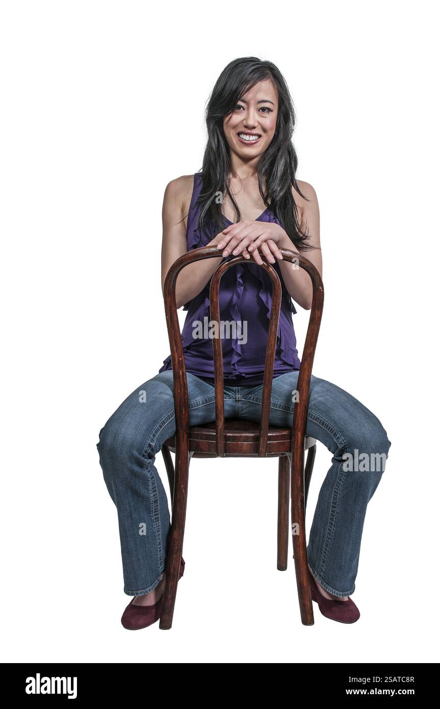 Beautiful young Asian woman sitting in a chair Stock Photo - Alamy