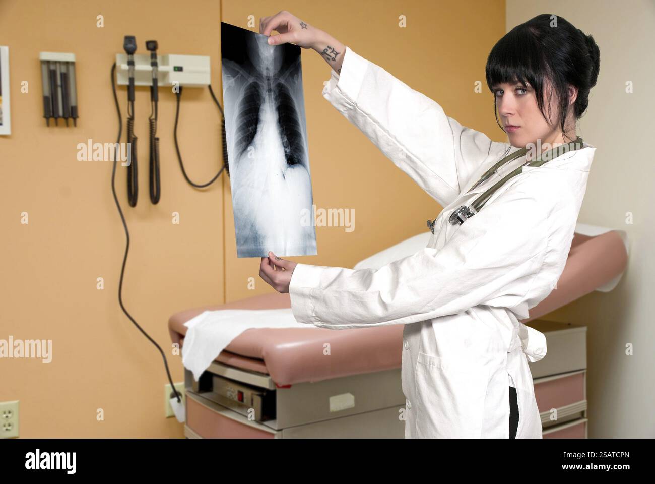 A beautiful female radiologist examining an x-ray Stock Photo - Alamy