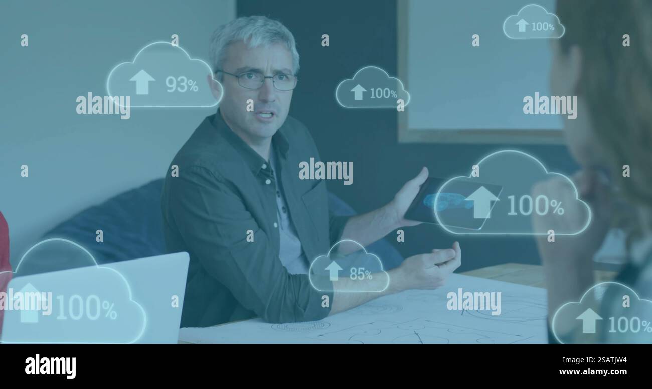 Image of clouds with percent growing over caucasian businessman using tablet Stock Photo