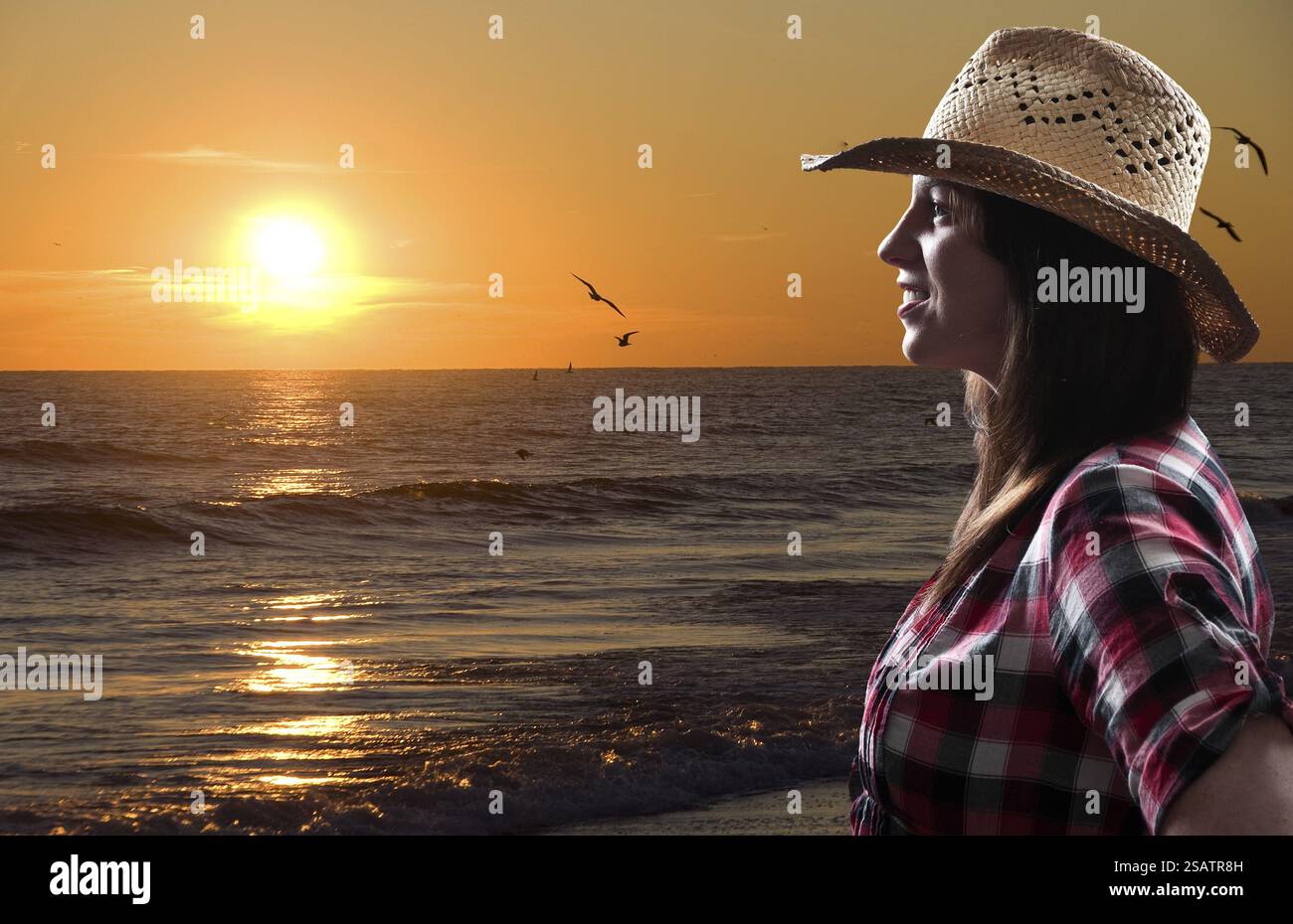 Beautiful young woman in front of a sunset Stock Photo