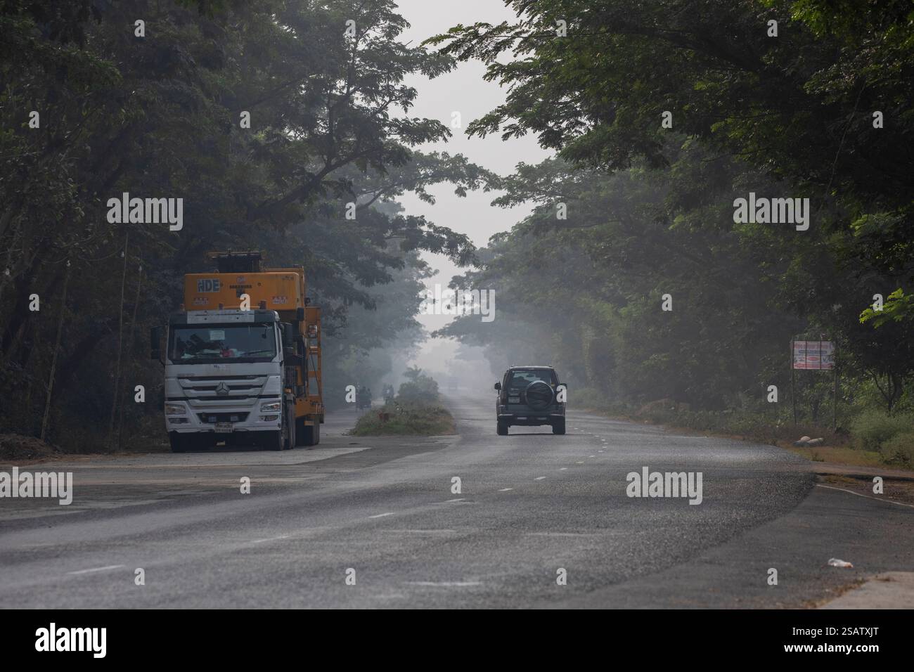A heavy truck and a SUV crossing the road in Chalanbil, Pabna district ...