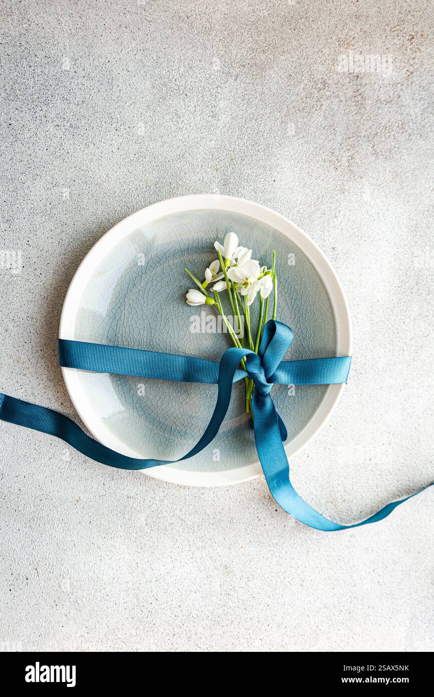 Table setting with snowdrops and ribbon Stock Photo