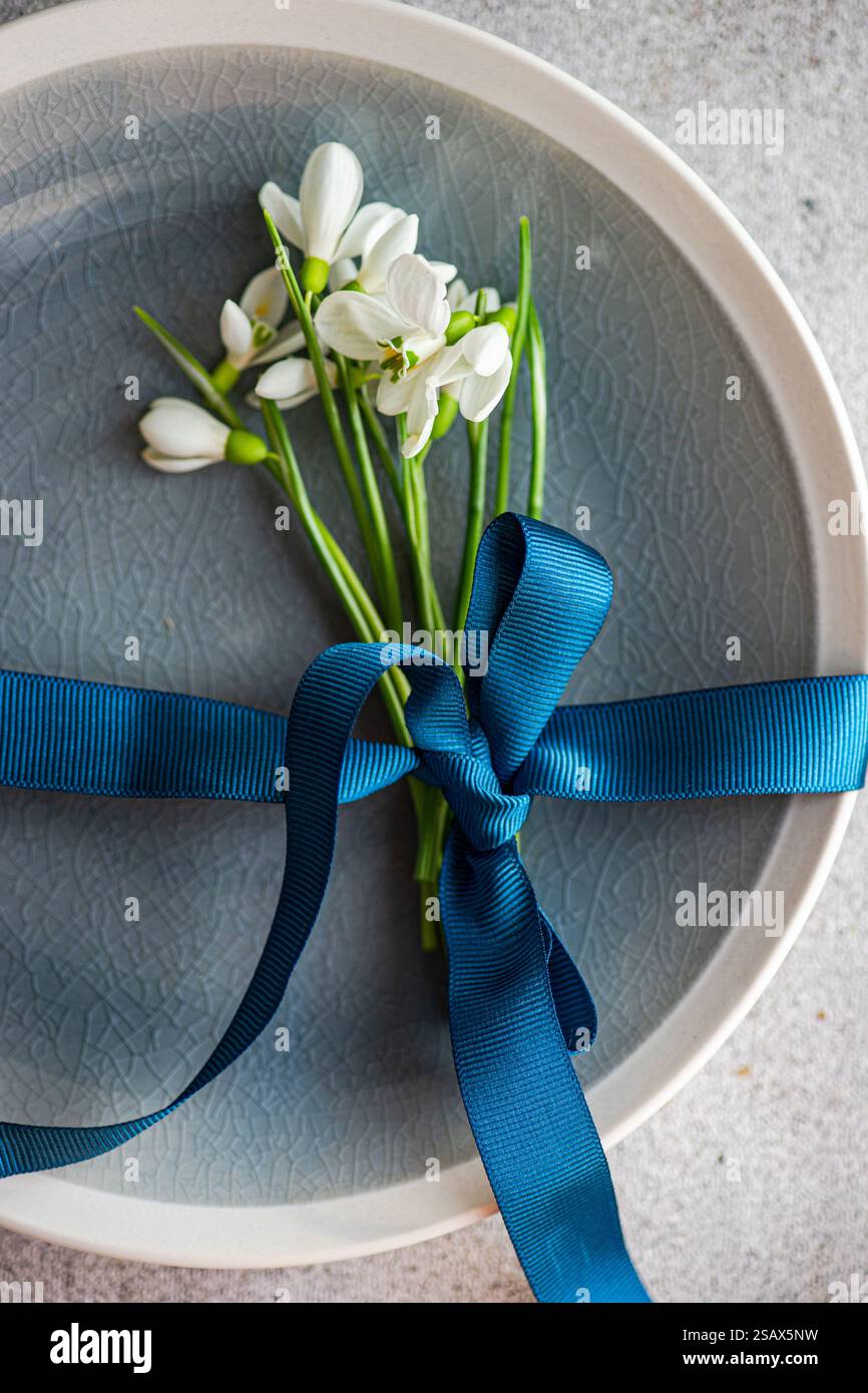 Table setting with snowdrops and ribbon Stock Photo