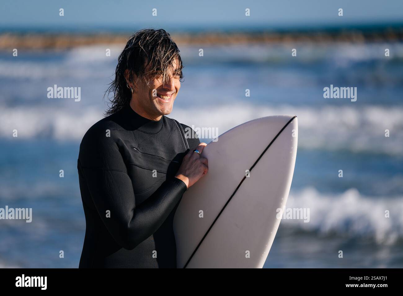 Smiling surfer holding surfboard hi-res stock photography and images ...