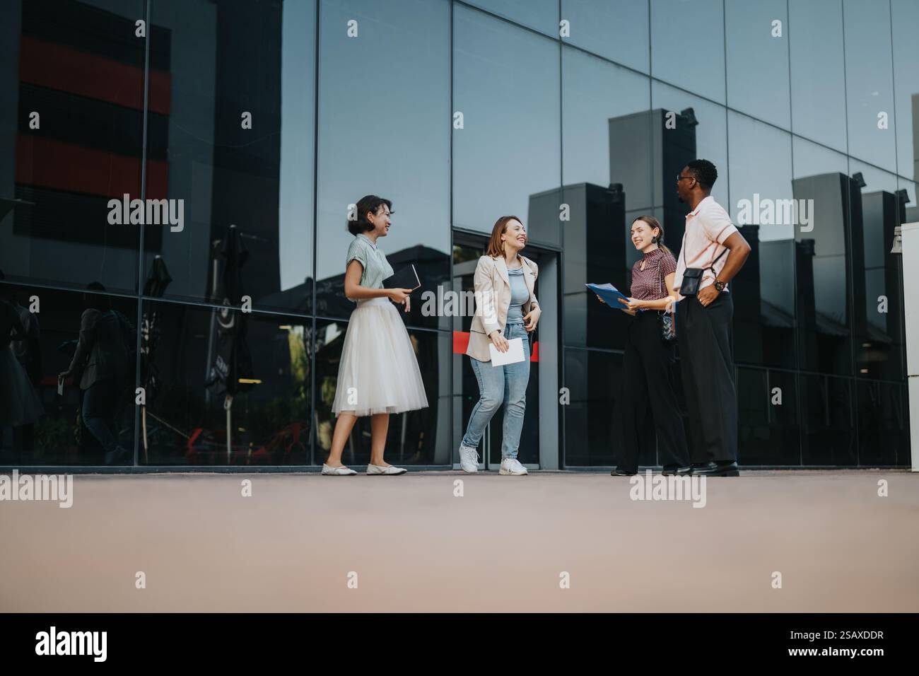 Multicultural professionals meeting outside urban office building Stock ...