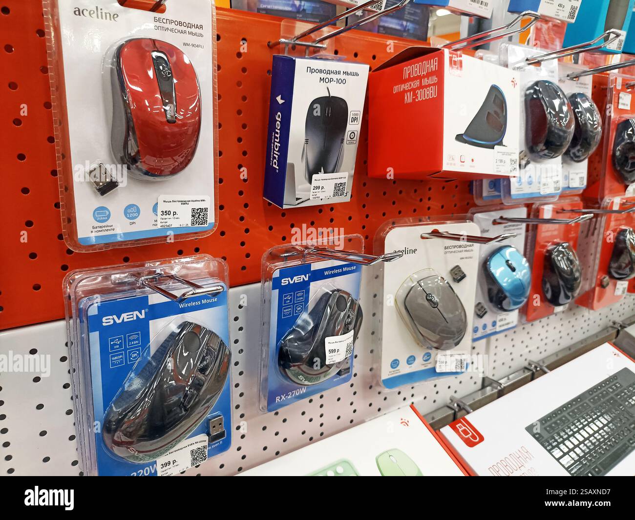 Assorted computer mice displayed on store shelves in retail packaging. Stock Photo