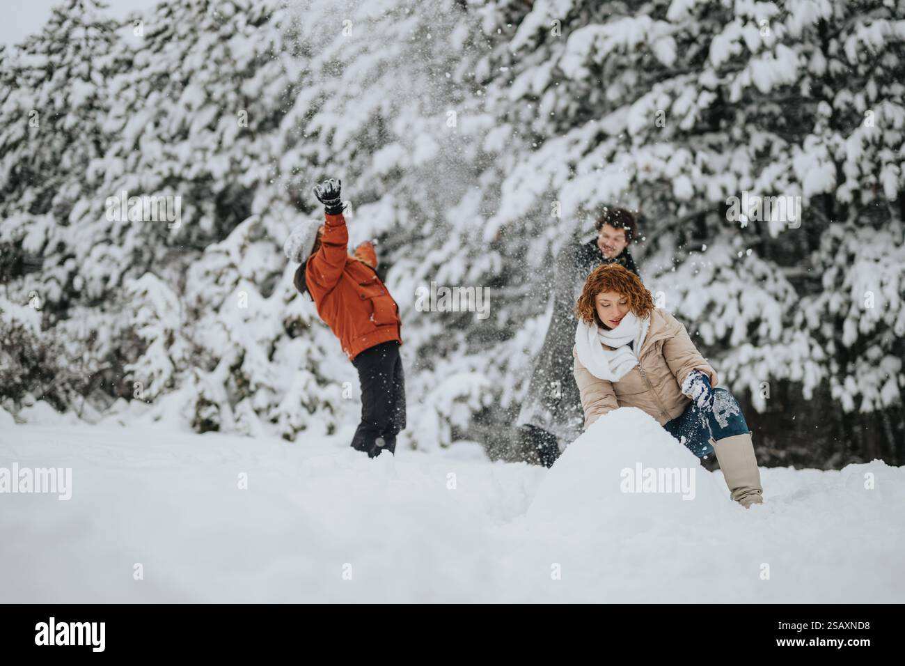 Group of friends enjoying outdoor winter activities in a snowy forest ...