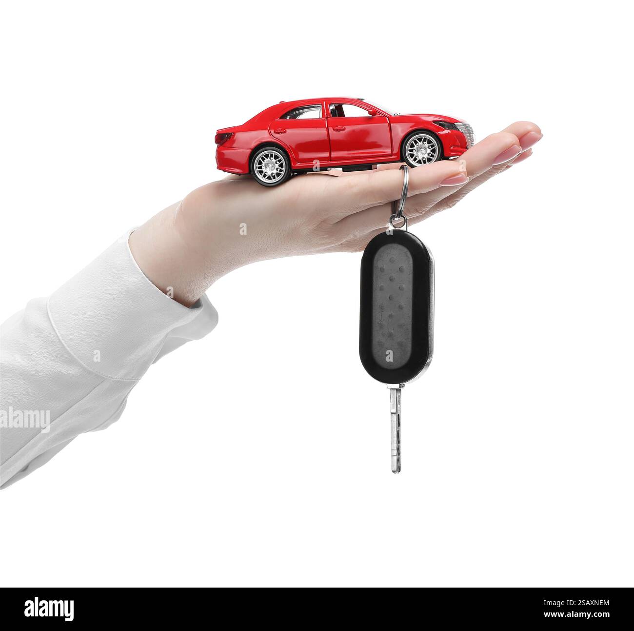 Woman with car model and key on white background, closeup. Buying auto Stock Photo