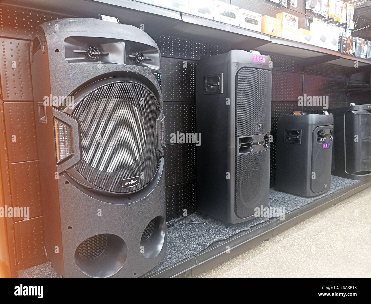 Large black portable speakers on display shelf in electronics store ...