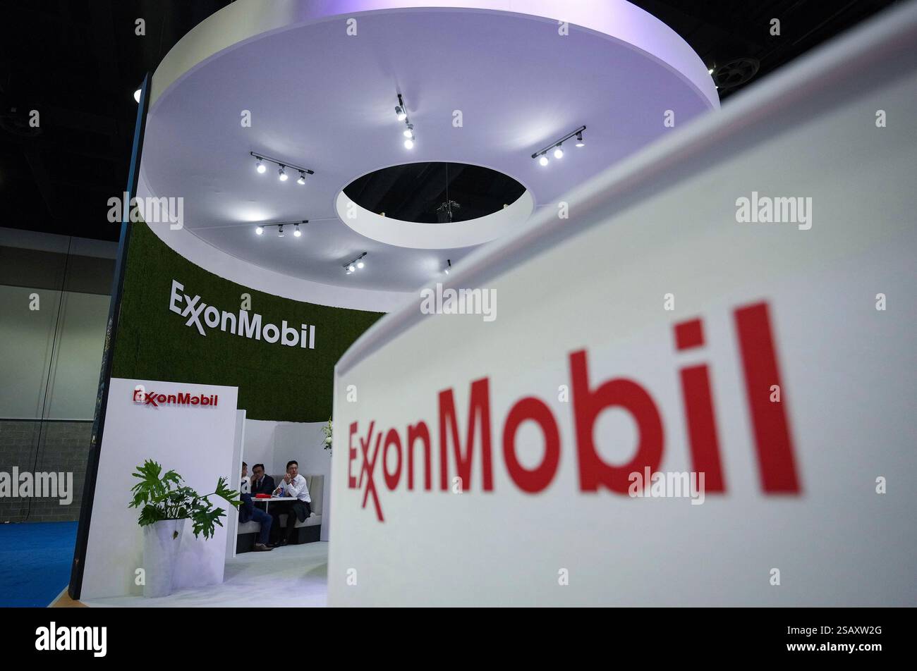 FILE - Delegates meet at the Exxon Mobil booth during the LNG2023 ...
