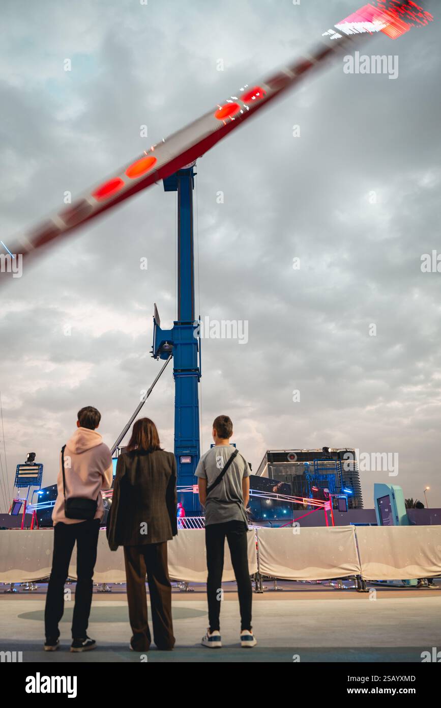 People Watching a Thrill Ride at an Amusement Park. Saudi Arabia Stock ...