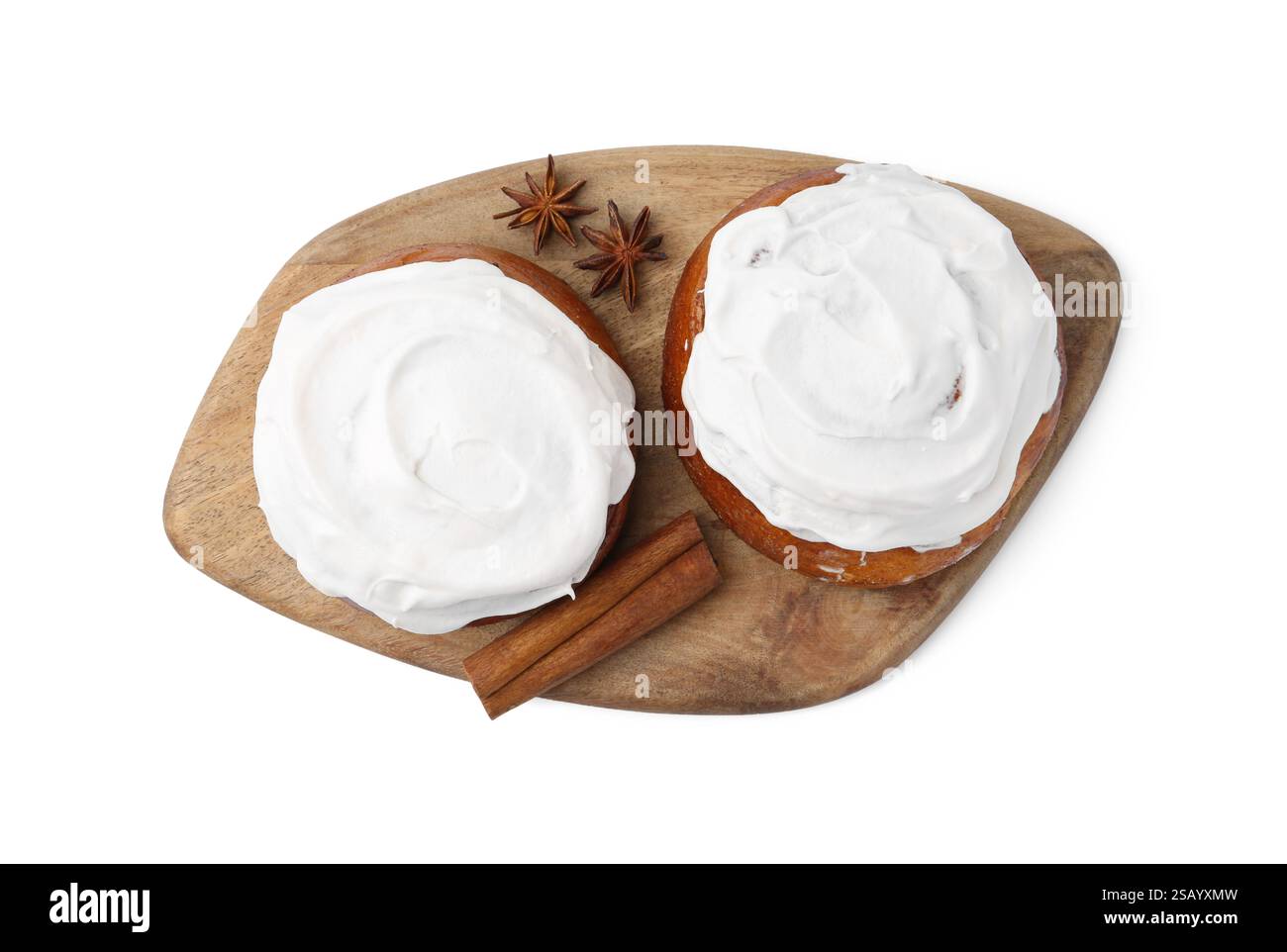 Tasty cinnamon rolls with cream and spices isolated on white, top view ...