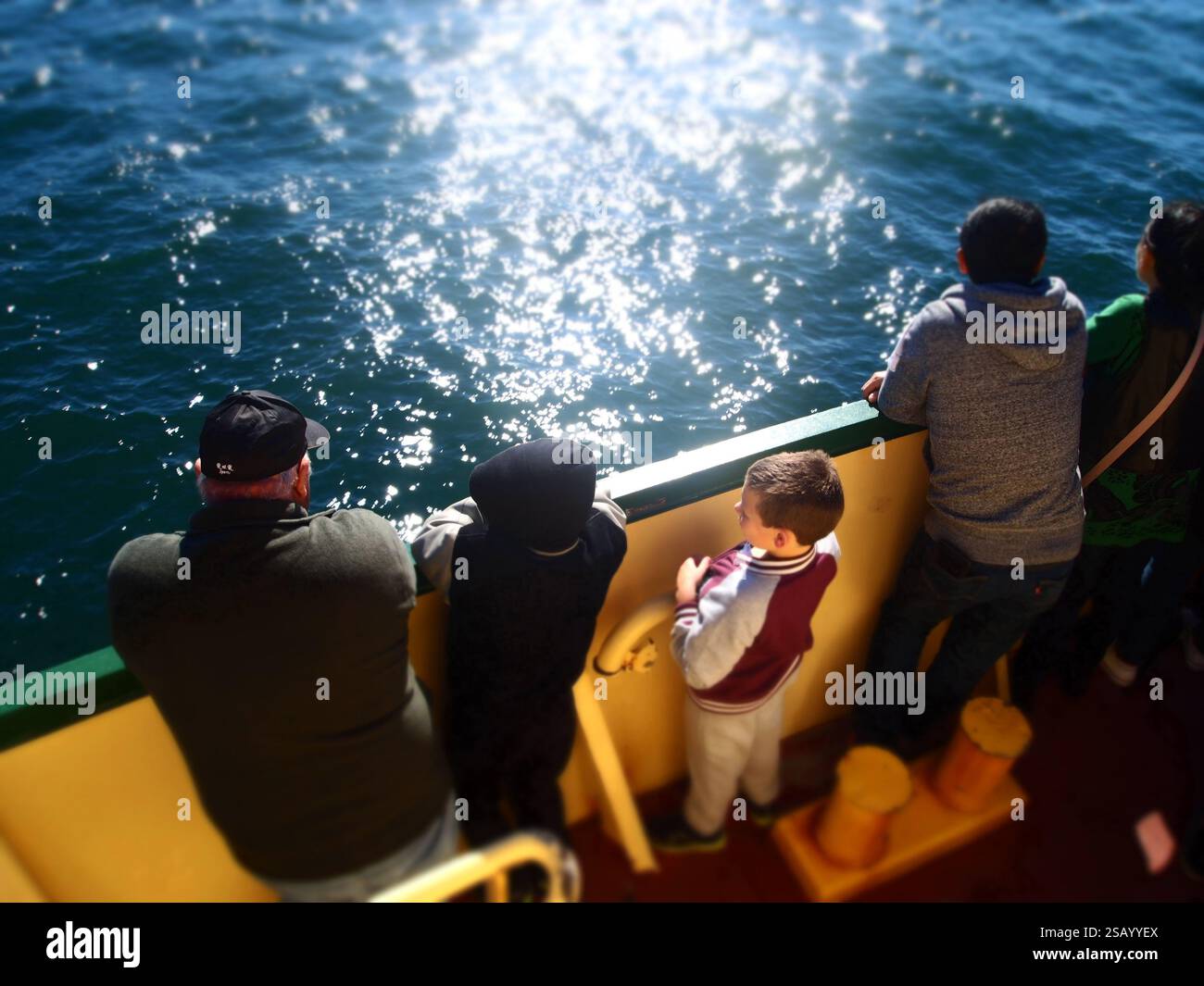 A boy with family on a ferry Stock Photo - Alamy